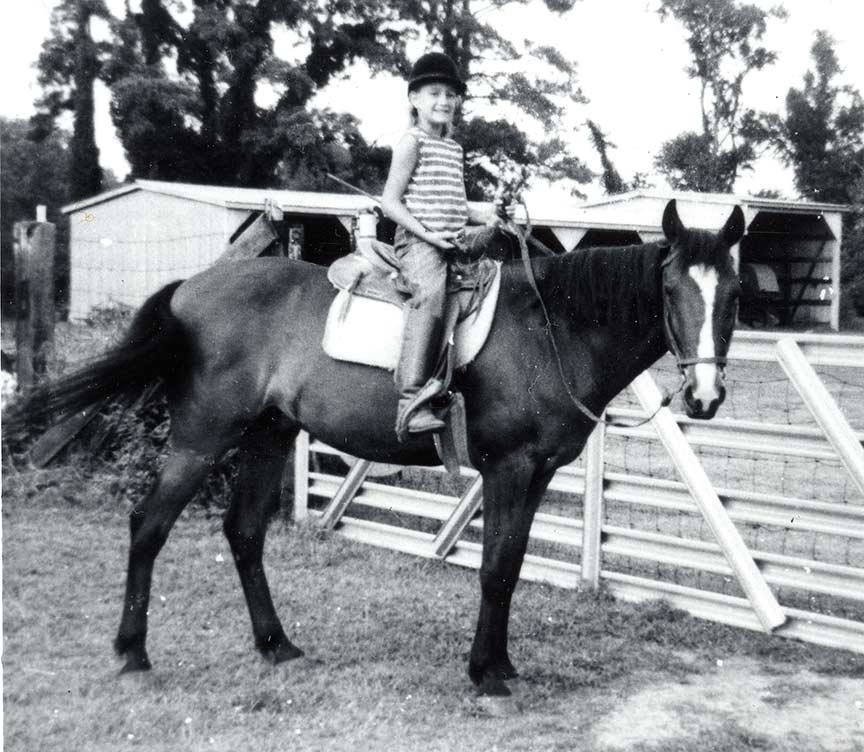Quinne as a child, on a horse
